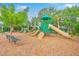 Community playground with multiple slides, climbing structures, and seating in a wood-chip area at 2269 Hartfords Bluff Cir, Mount Pleasant, SC 29466