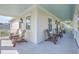 Inviting outdoor porch perfect for enjoying the fresh air, furnished with Adirondack chairs at 2269 Hartfords Bluff Cir, Mount Pleasant, SC 29466