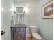 Stylish powder room featuring shiplap walls, elegant vanity, and modern fixtures at 2269 Hartfords Bluff Cir, Mount Pleasant, SC 29466