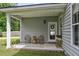 Charming back porch with wicker chairs and a view of the garden at 243 Old Savannah Dr, Goose Creek, SC 29445