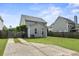 Backyard featuring a spacious concrete patio, partial fencing, well-maintained lawn, and access to the home at 243 Old Savannah Dr, Goose Creek, SC 29445