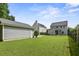 Large backyard showcasing a well-maintained lawn, fencing, and the rear exteriors of multiple homes at 243 Old Savannah Dr, Goose Creek, SC 29445