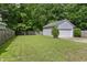 Spacious backyard featuring a detached garage and lush lawn, perfect for outdoor activities and relaxation at 243 Old Savannah Dr, Goose Creek, SC 29445