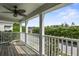 Charming balcony with white railings, a ceiling fan, and views of the surrounding greenery at 243 Old Savannah Dr, Goose Creek, SC 29445