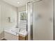 Relaxing bathroom with a soaking tub, frosted glass shower door, and window at 243 Old Savannah Dr, Goose Creek, SC 29445