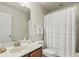 Well-lit bathroom featuring a shower with white curtain and a granite countertop sink at 243 Old Savannah Dr, Goose Creek, SC 29445