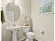 Cozy bathroom with a pedestal sink, toilet, and a window providing natural light at 243 Old Savannah Dr, Goose Creek, SC 29445