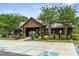 Exterior of the community clubhouse featuring lush landscaping, accessible parking, and a welcoming entrance at 243 Old Savannah Dr, Goose Creek, SC 29445