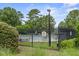 Community pool enclosed by a black metal fence, offering a safe and inviting recreational space at 243 Old Savannah Dr, Goose Creek, SC 29445