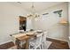 Charming dining room with a wooden table, chandelier, and bright windows, perfect for entertaining guests at 243 Old Savannah Dr, Goose Creek, SC 29445