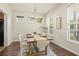 Bright dining room with wooden table, chandelier, and natural light, creating an inviting atmosphere at 243 Old Savannah Dr, Goose Creek, SC 29445