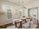 Elegant dining room featuring a wooden table, chandelier, and windows, perfect for Gathering gatherings at 243 Old Savannah Dr, Goose Creek, SC 29445