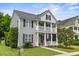 Charming two-story home with double porches and American flag, perfect for relaxing and enjoying the outdoors at 243 Old Savannah Dr, Goose Creek, SC 29445