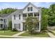 Charming two-story home featuring double porches, gray siding, black shutters, and a well-manicured lawn at 243 Old Savannah Dr, Goose Creek, SC 29445