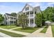 Two-story house with a driveway, a small tree, and a white picket fence at 243 Old Savannah Dr, Goose Creek, SC 29445