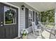 Inviting front porch with rocking chairs, floral arrangements, and seasonal wreath, offering a cozy welcome at 243 Old Savannah Dr, Goose Creek, SC 29445