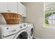 Well-organized laundry area with a washer, dryer, and storage cabinets at 243 Old Savannah Dr, Goose Creek, SC 29445