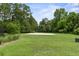 Community sand volleyball court surrounded by lush greenery, offering a fun and active recreational space at 243 Old Savannah Dr, Goose Creek, SC 29445