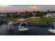 Aerial view of a waterfront neighborhood showing private docks with boat lifts, lush greenery and marsh grasses at 27 Rebellion Rd, Charleston, SC 29407