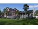 Expansive backyard featuring a lush lawn, mature trees, and a stylish home exterior at 27 Rebellion Rd, Charleston, SC 29407