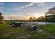 Multiple boat trailers parked on a grassy lot, ready for your next adventure at 27 Rebellion Rd, Charleston, SC 29407