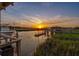 Sunset view of a gazebo on the dock, offering an idyllic waterfront experience at 27 Rebellion Rd, Charleston, SC 29407