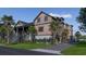Charming home exterior with mature palm trees, lush landscaping, and a welcoming front porch at 27 Rebellion Rd, Charleston, SC 29407