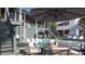 Backyard pool with an umbrella, dining set, lounge chairs, and stylish patio at 27 Rebellion Rd, Charleston, SC 29407