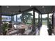 Inviting covered porch with comfortable seating, ceiling fans, and picturesque views of the yard at 27 Rebellion Rd, Charleston, SC 29407