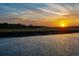 Scenic water view at sunset with lush marsh grasses along the shoreline at 27 Rebellion Rd, Charleston, SC 29407