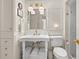 Pristine white bathroom featuring traditional fixtures, a vintage-style sink, and classic design elements at 286 Meeting St # C, Charleston, SC 29407