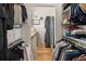 Organized walk-in closet with ample hanging space, shelving, and a convenient laundry area at 286 Meeting St # C, Charleston, SC 29407