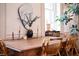 Bright dining room featuring a wood table with seating, decorative mirror and plant at 286 Meeting St # C, Charleston, SC 29407