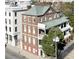 Beautiful brick home featuring a green roof, symmetrical windows, and a charming balcony at 286 Meeting St # C, Charleston, SC 29407