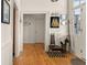 Inviting foyer with hardwood floors, bright natural light, stylish decor, and convenient coat rack near the entrance at 286 Meeting St # C, Charleston, SC 29407