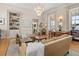 Elegant living room featuring a modern chandelier, hardwood floors, and built in book cases at 286 Meeting St # C, Charleston, SC 29407