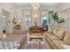 Bright living room featuring hardwood floors, white trim, chandelier, and dining area at 286 Meeting St # C, Charleston, SC 29407