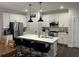 Modern kitchen features white cabinets, stainless steel appliances, and a large center island with bar seating at 31 Wedgepark Rd, Charleston, SC 29407