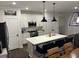 Bright kitchen features white cabinets, stainless steel appliances and large island at 31 Wedgepark Rd, Charleston, SC 29407