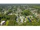 Aerial view showcasing a community with lush trees, serene ponds, and well-maintained homes in a planned development at 3202 Middleburry Ln, Charleston, SC 29414