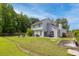 Expansive backyard featuring a well-maintained lawn, patio seating, and mature trees creating a serene outdoor space at 3202 Middleburry Ln, Charleston, SC 29414