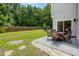 Outdoor patio with a dining set overlooking the grassy backyard at 3202 Middleburry Ln, Charleston, SC 29414