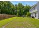 Private fenced backyard with lush greenery and space for outdoor activities and relaxation, including comfortable Adirondack chairs at 3202 Middleburry Ln, Charleston, SC 29414