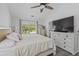 Well-lit bedroom features a large window, modern flooring, and a ceiling fan for added comfort at 3202 Middleburry Ln, Charleston, SC 29414