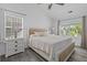 Bright bedroom with neutral tones, large windows, and a comfortable queen-sized bed with white bedding at 3202 Middleburry Ln, Charleston, SC 29414