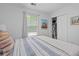 Cozy bedroom with a window, closet, bed with patterned bedding, and decor on the wall at 3202 Middleburry Ln, Charleston, SC 29414