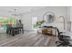 Sunlit dining room features modern chandelier and stylish gray flooring at 3202 Middleburry Ln, Charleston, SC 29414
