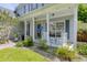 Inviting front porch with rocking chairs, a swing, and manicured landscaping at 3202 Middleburry Ln, Charleston, SC 29414