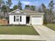 Charming single-story home featuring brick and siding accents, plus a well-maintained lawn and attached garage at 386 Spruce Ivy St, Moncks Corner, SC 29461