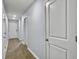 Hallway with white doors, wood flooring, and light-colored walls at 386 Spruce Ivy St, Moncks Corner, SC 29461